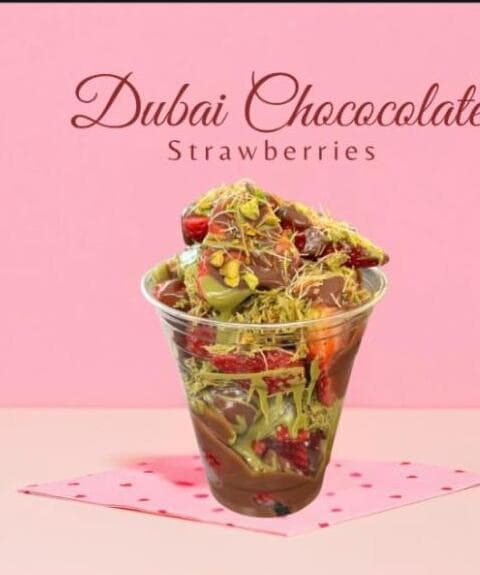 Chocolate-dipped Dubai strawberries with pistachio in a cup