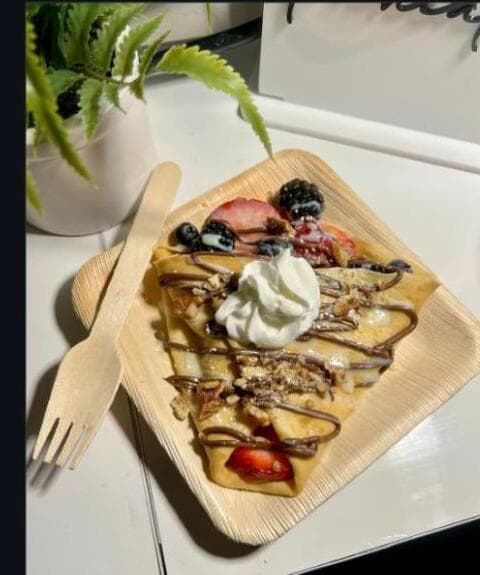 Berry and chocolate crepe presentation at an event